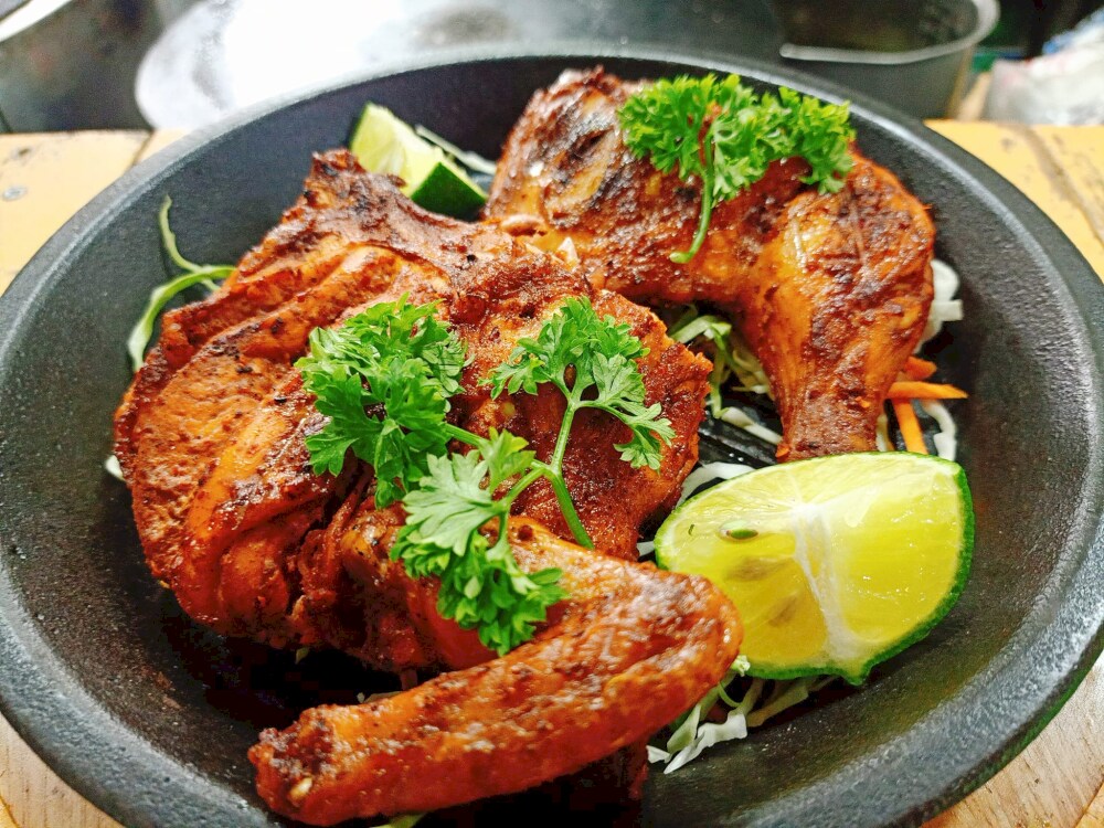 The restaurant's half-roasted chicken is exquisitely displayed in a bowl